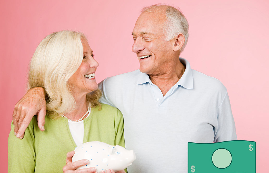 senior couple holding a piggy bank